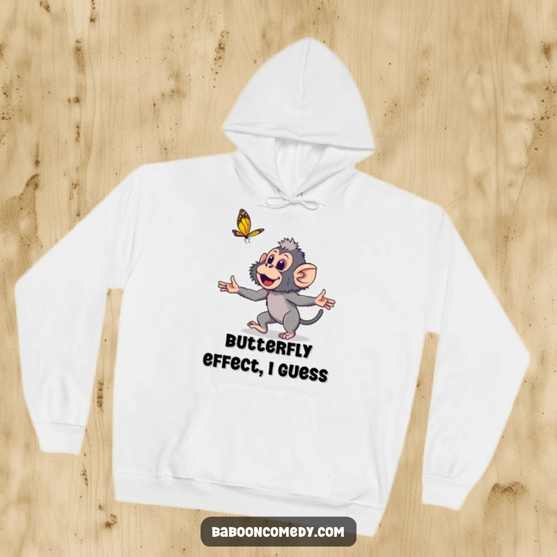 Funny young baboon hoodie featuring a cute primate with open arms, playfully chasing a fluttering butterfly, embodying pure, lighthearted fun.