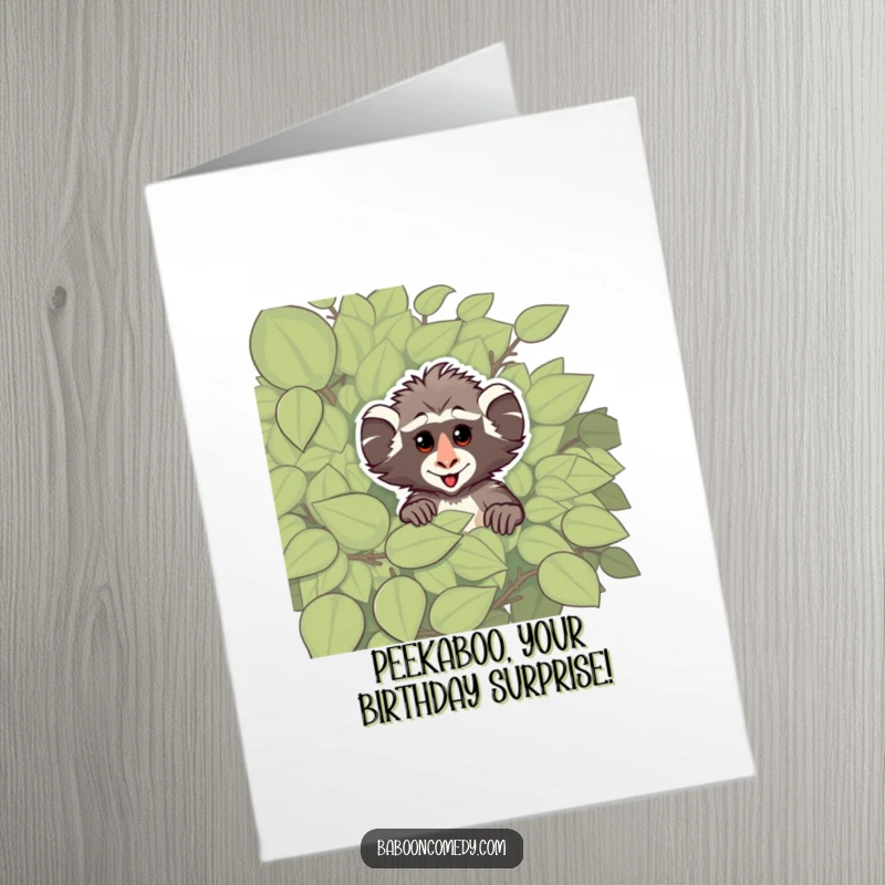 Funny Free Printable Birthday Card: Cheeky baboon peeking from behind a leafy bush with a mischievous twinkle.