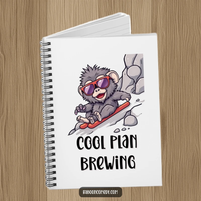 Funny kawaii baboon notebook, a cool primate in oversized sunglasses sliding down a rocky slope, perfect for jotting down adventures.