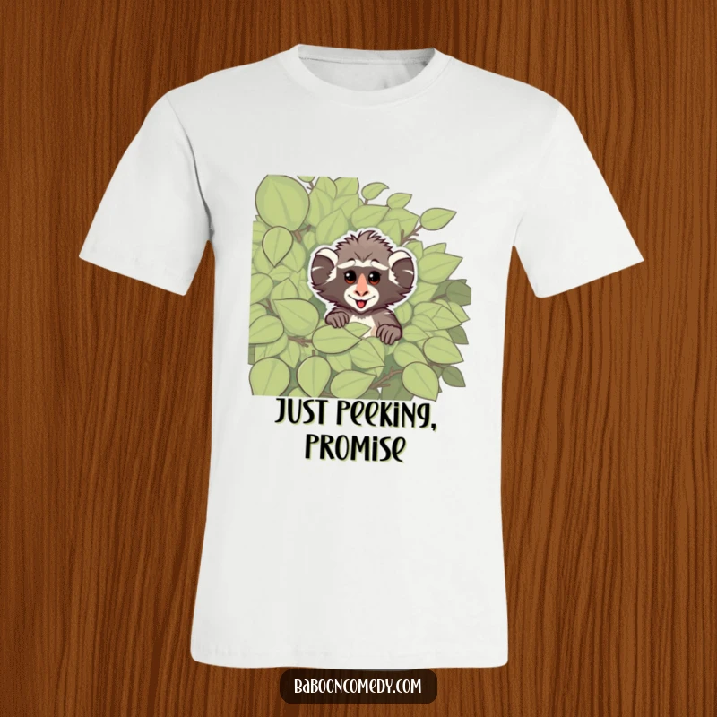 Funny t-shirt with a cheeky baboon peeking from behind a leafy bush, designed to evoke playful curiosity and primate-themed humor.