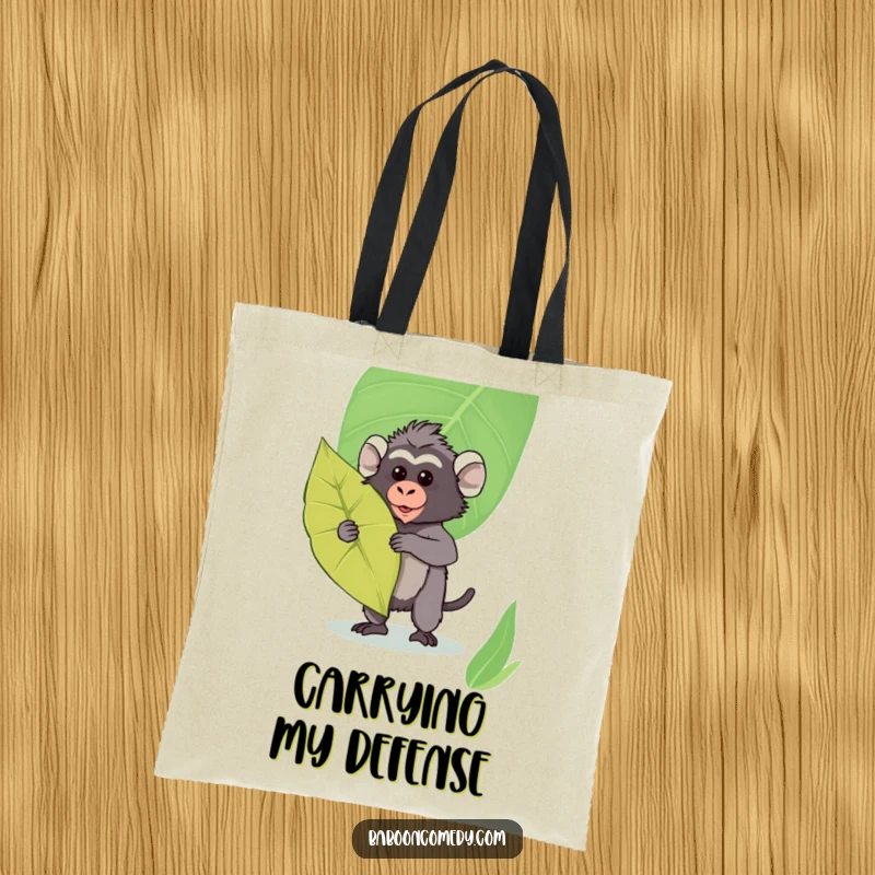 Funny Kawaii Baboon Tote Bag: Cute baboon holding a large leaf as a shield, ready to carry your belongings with style.