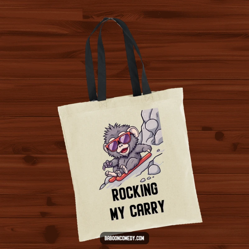 Funny kawaii baboon tote bag, a primate in oversized shades sliding down a rocky slope, adding cool humor to errands.